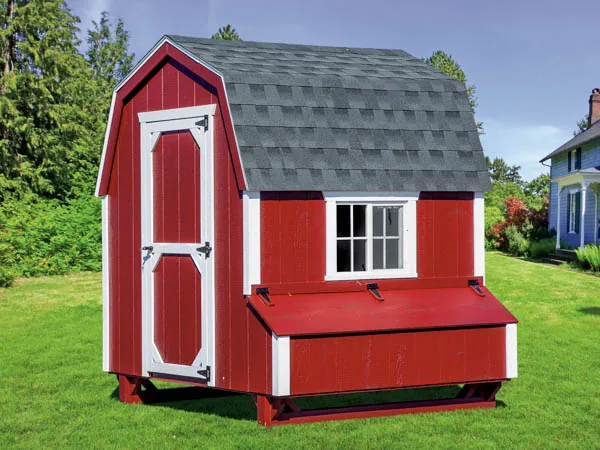 Red barn-style chicken coop with gambrel roof
