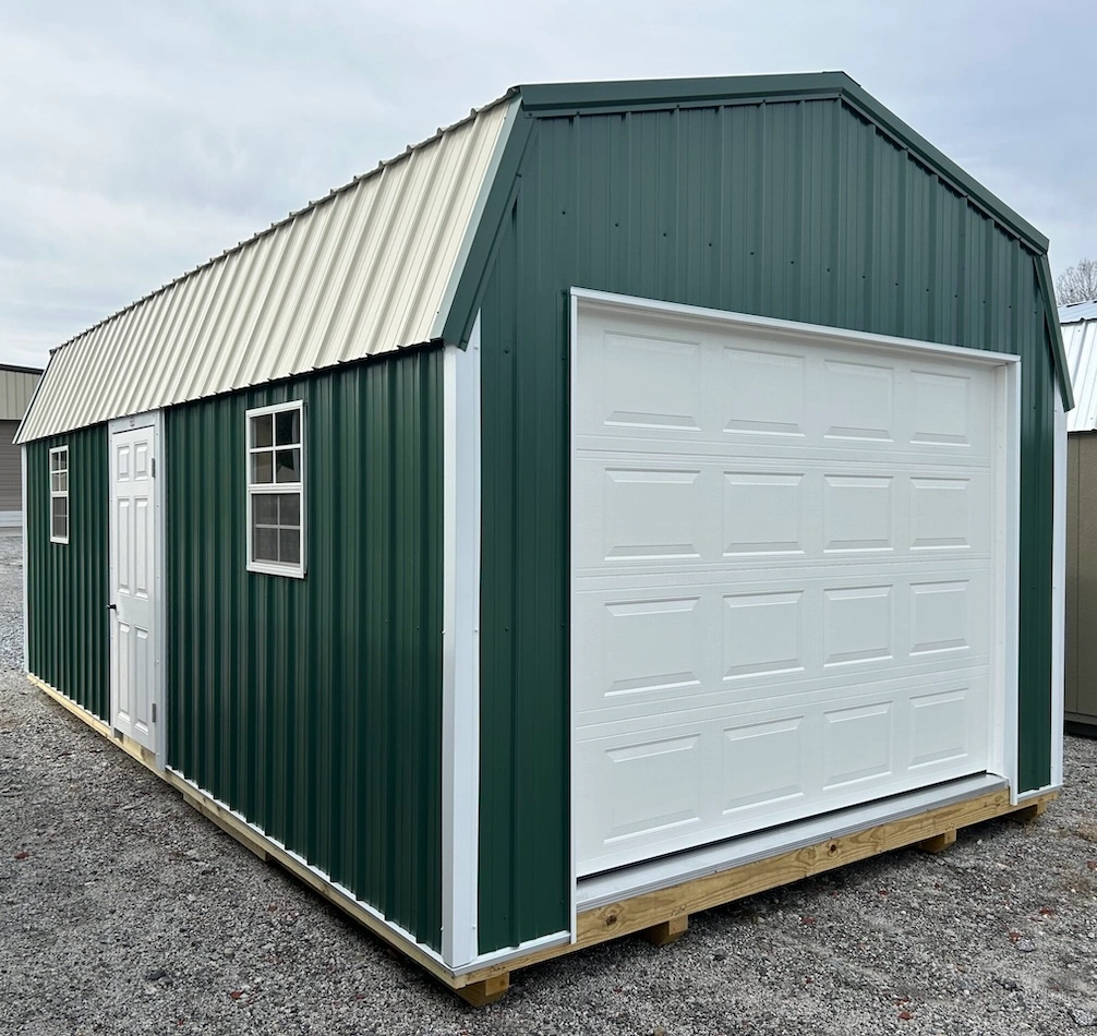 Green lofted garage with white overhead door