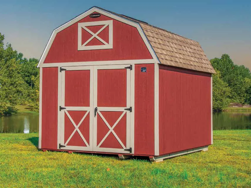 Barn-red custom build with cream X-brace doors under a gray gambrel roof