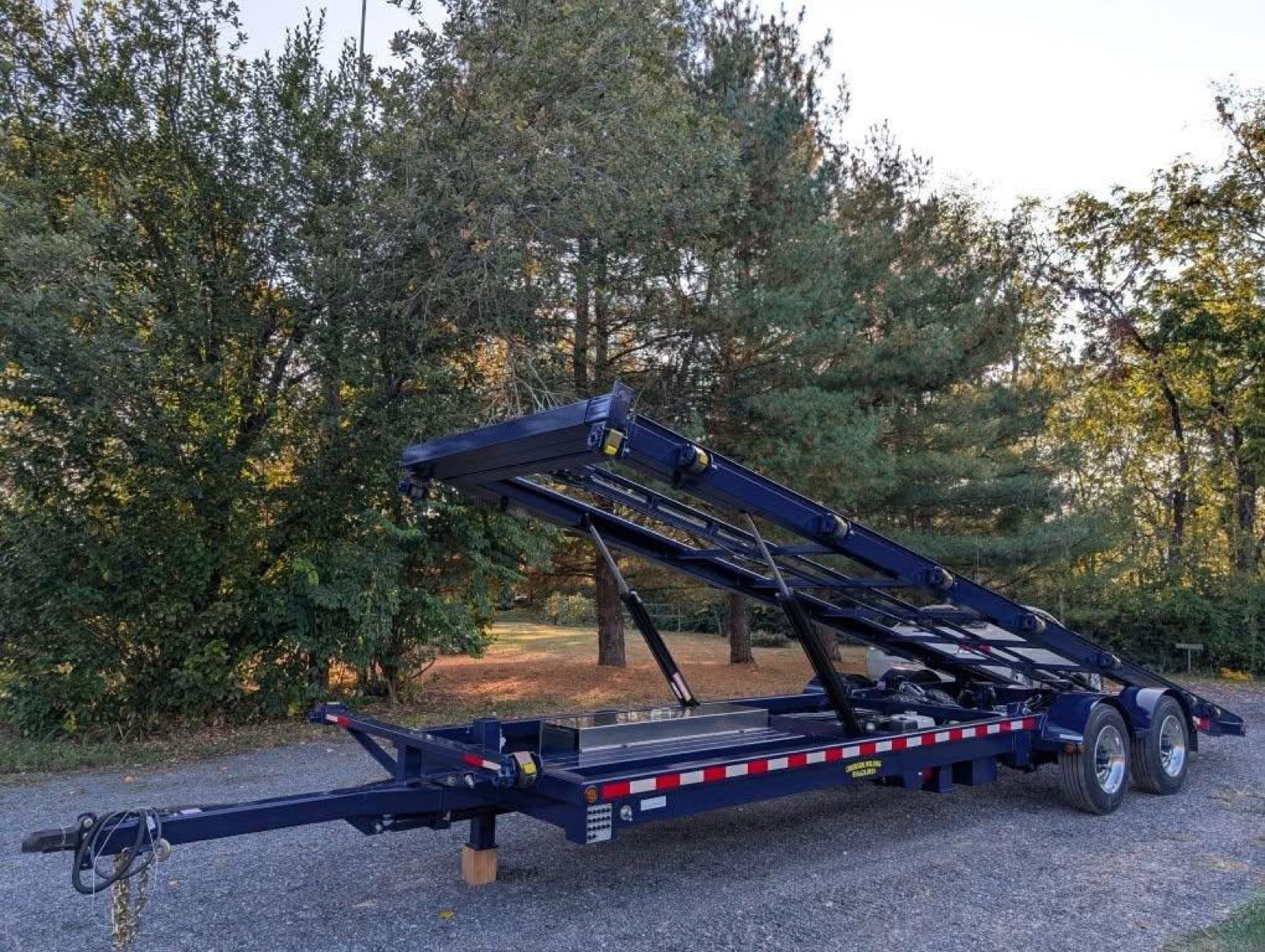 Navy Creekside tri-axle shed trailer with the deck raised